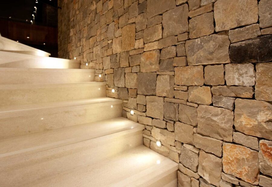 Staircase along the stone wall